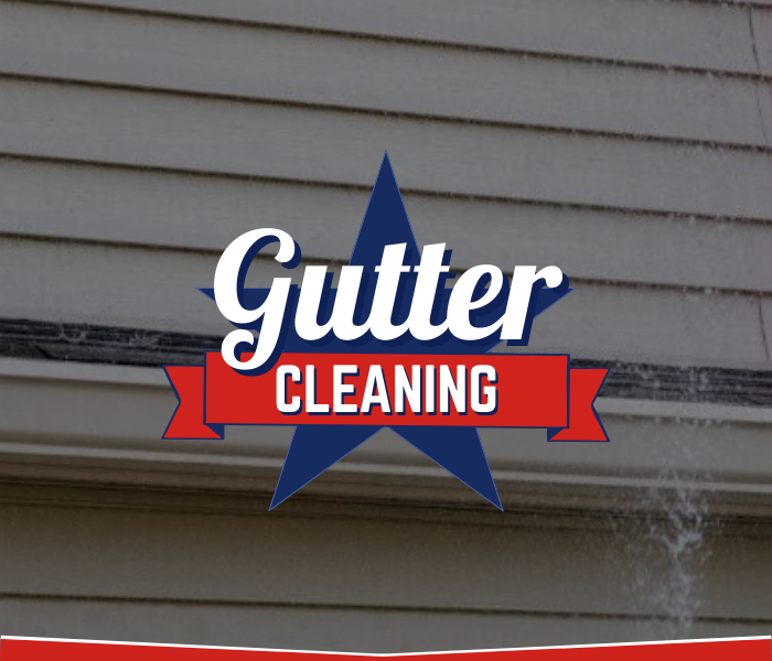 Dirty residential gutter and siding prepared for cleaning by Great American Soft Wash.