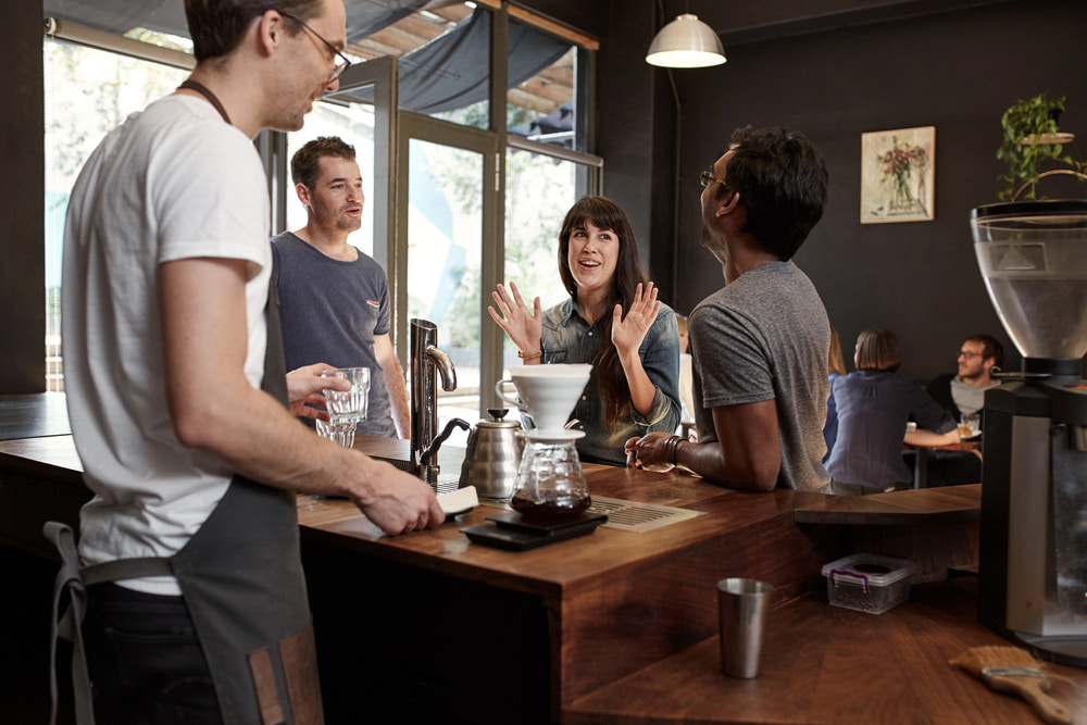 Woman talking with colleagues and gesturing with hands