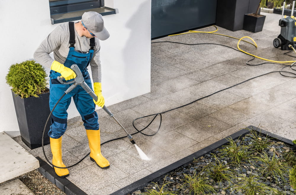 Caucasian Men Pressure Washing His House